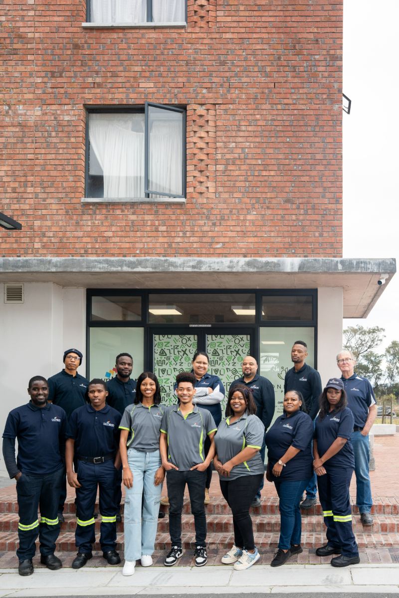 Company team group portrait outside their offices in Cape Town